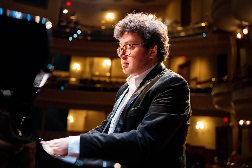 Veniamin Blokh seated at a grand piano